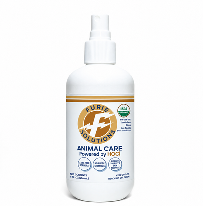 A white plastic spray bottle of Furie Solutions Animal Care spray, featuring a white pump cap and a label with gold, blue, and green accents, set against a plain white background.