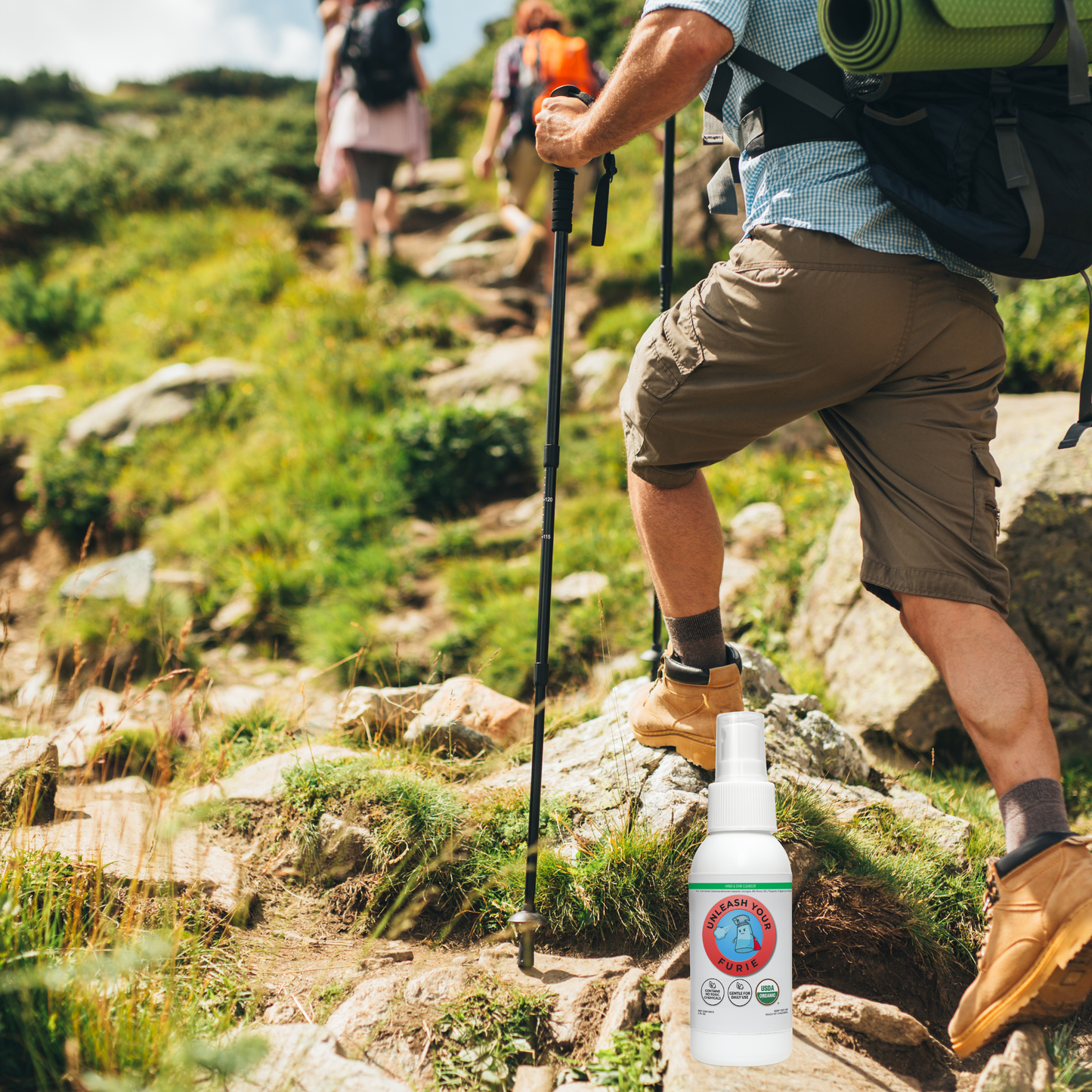 Person hiking on a trail with a bottle of FURIE Hand & Skin spray in the on a rock